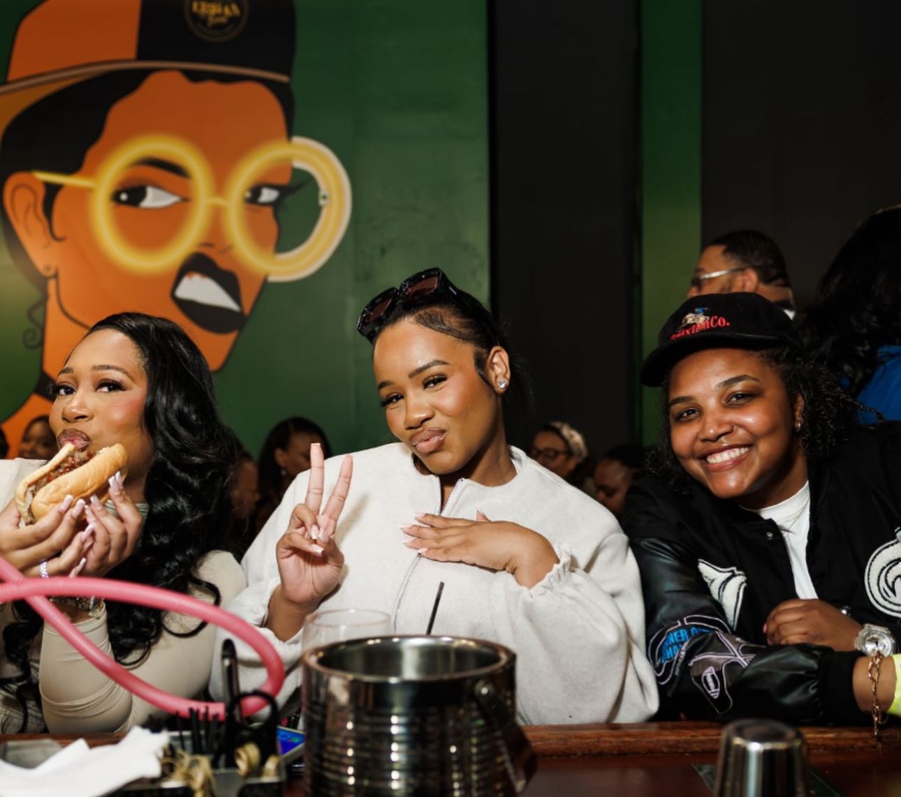 Friends at the bar in front of the Urban Fork mural